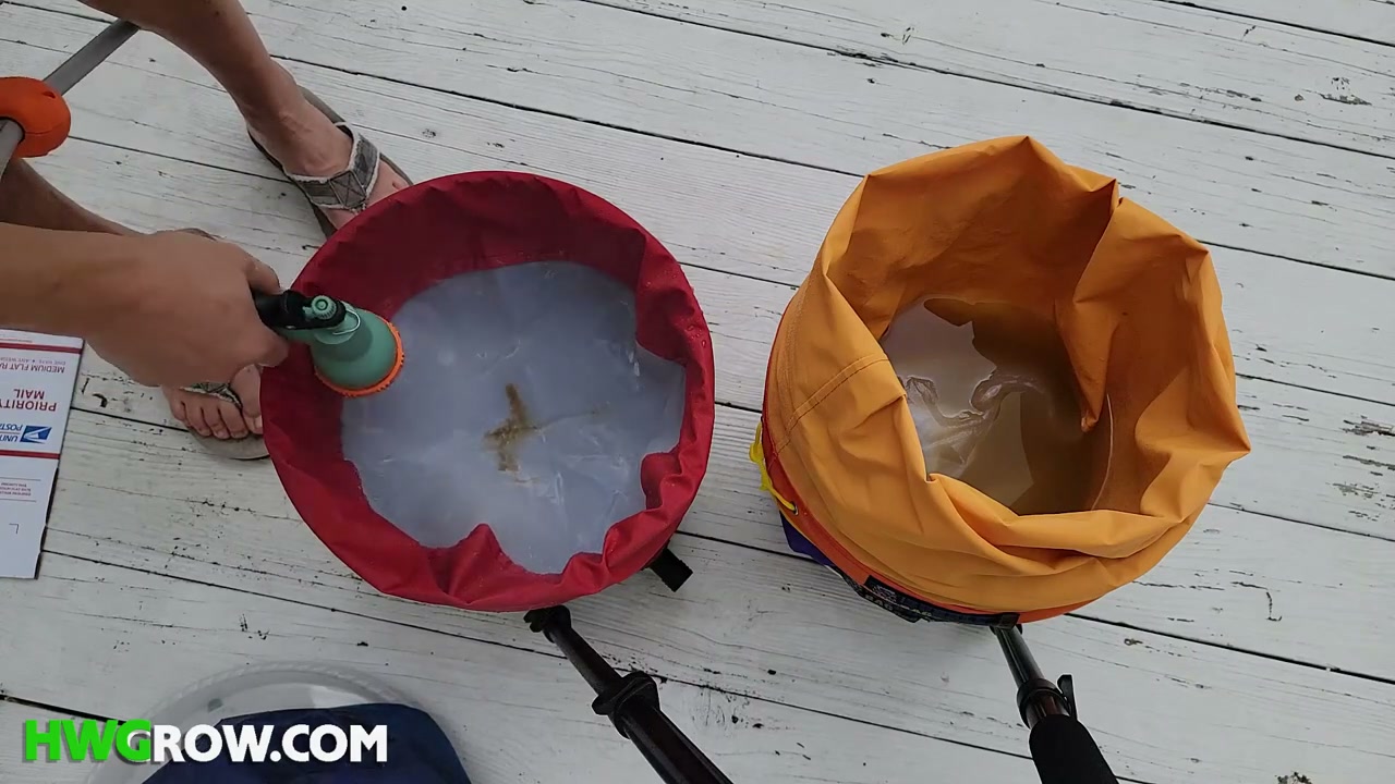 Cold wash water draining from a mini washer into a stacked set of bubble bags