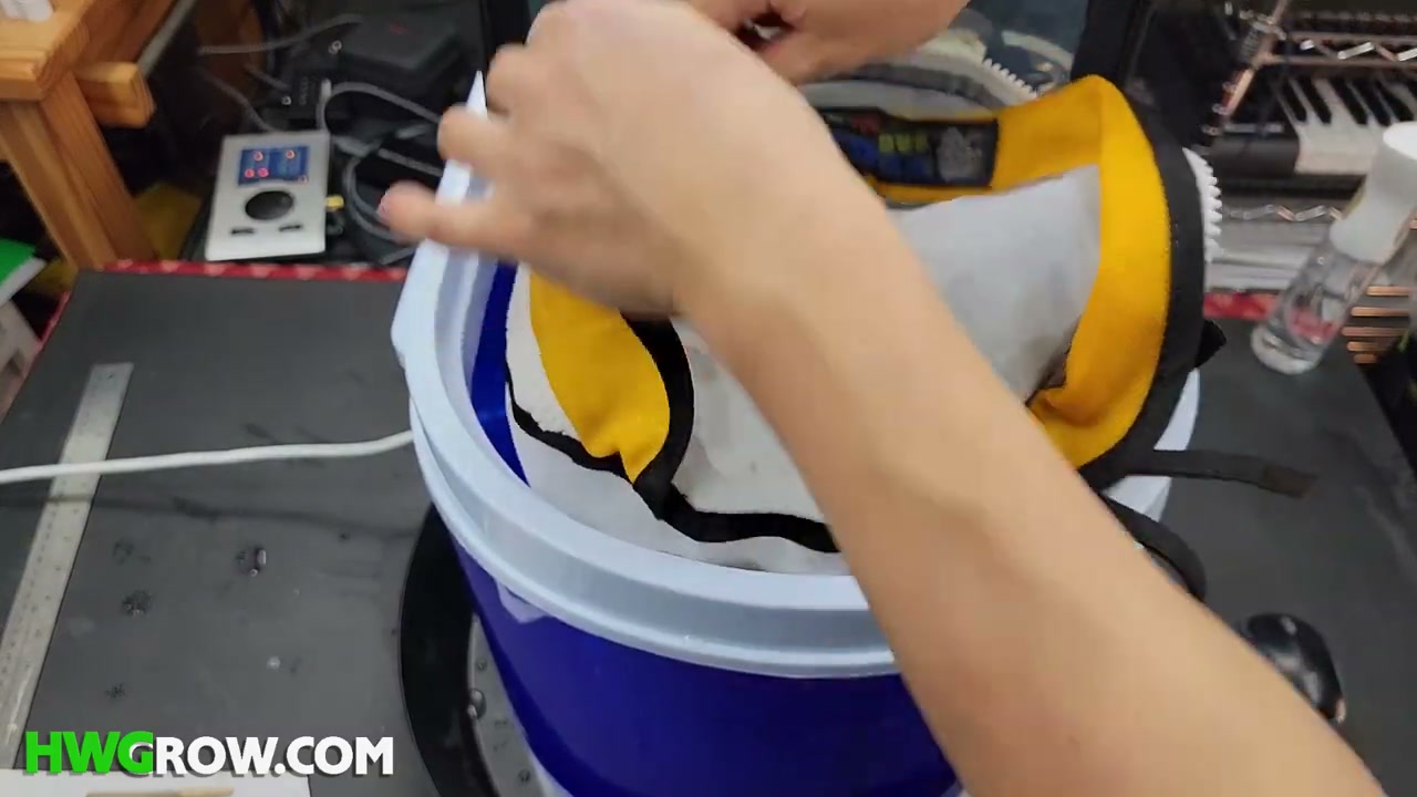 Five-gallon mini washer loaded with a secured work bag, ice and cold water for ice-water hash